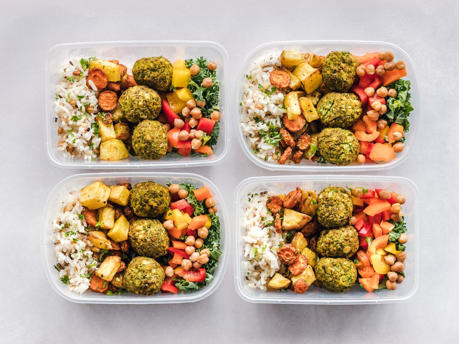 Colorful balanced meal bowl with falafel, chickpeas, rice, and fresh vegetables — no food groups excluded